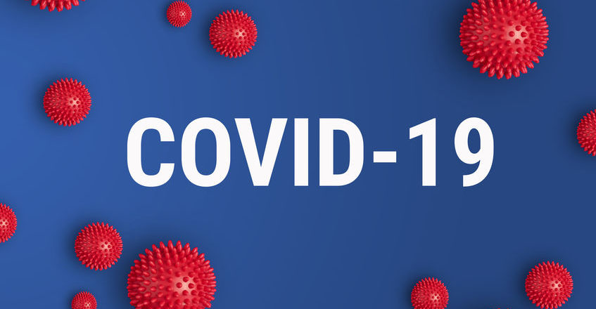 Inscription COVID-19 on blue background with red strain model of coronavirus